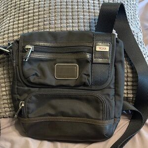 Tumi Blackish/brown Messenger Bag with Adjustable Strap and luggage tag.